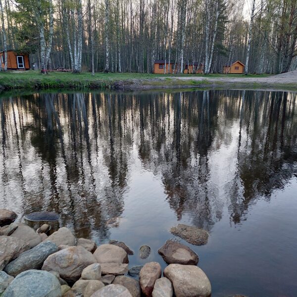 Across the pond you can see three camping cabins and on the left the communal kitchen.